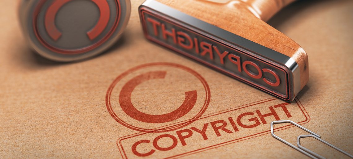 3D illustration of two rubber stamps with copyright word and symbol over kraft paper background, Concept of copyrighted material