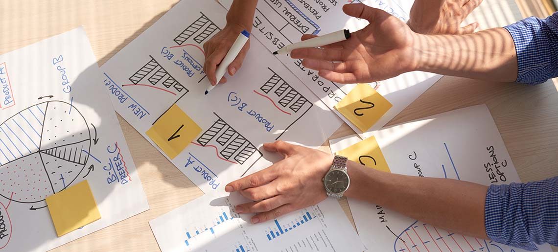 Business people discussing charts and diagrams, view from above