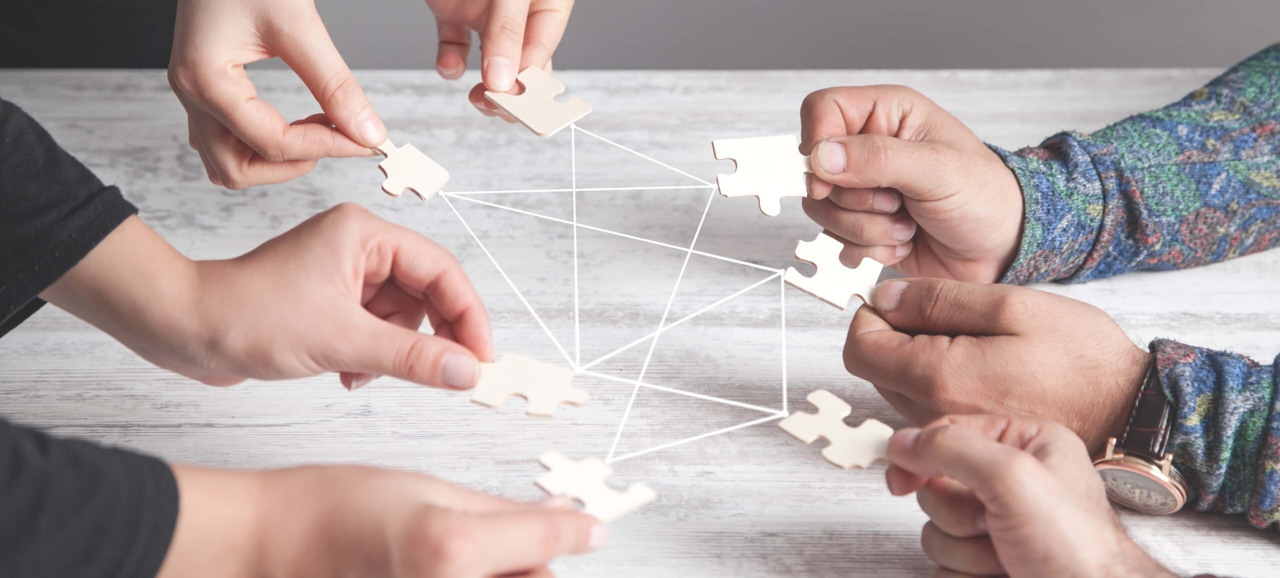 Hands of people holding jigsaw puzzle. Connection, Partnership, Success, Teamwork